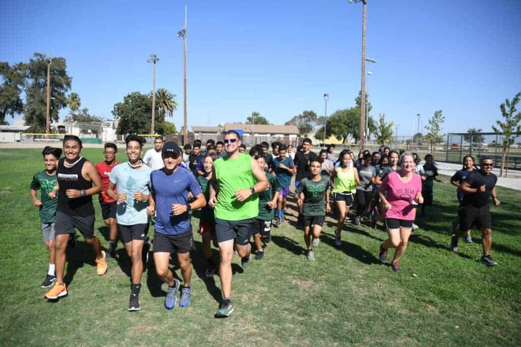 Photo - In front of the Madera South Stallions cross country team are, from left, co-head coaches Benny Madrigal and Sky Fierro, along with assistants Christin Beaulieu and Ramon Delgadillo.