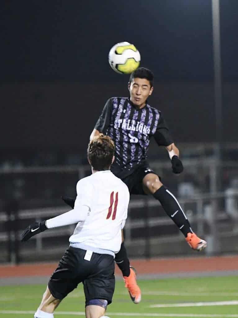 Photo - Madera South’s Daniel Maciel rises up to send a header on goal for the first score in Tuesday’s victory over Clovis West.
