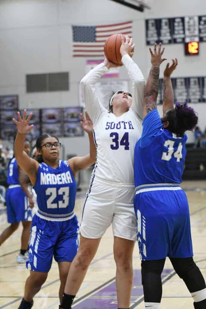 Photo - Madera South’s Arelis Chavez goes up for two of her game-high 14 points against Madera’ Shalynn Garcia during Wednesday’s victory.