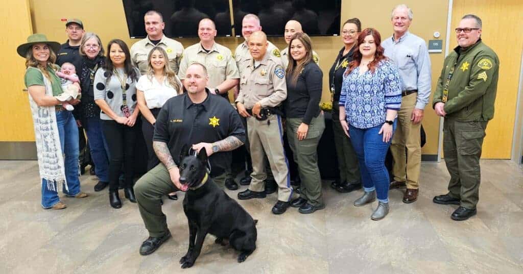 Photo - With his handler Corporal Logan Majeski, apprehension dog Nacho is surrounded by members of the Madera County Sheriff’s Office, California Highway Patrol officer Javier Ruvalcaba and Madera County Supervisor Robert Poythress, to celebrate Nacho’s retirement.