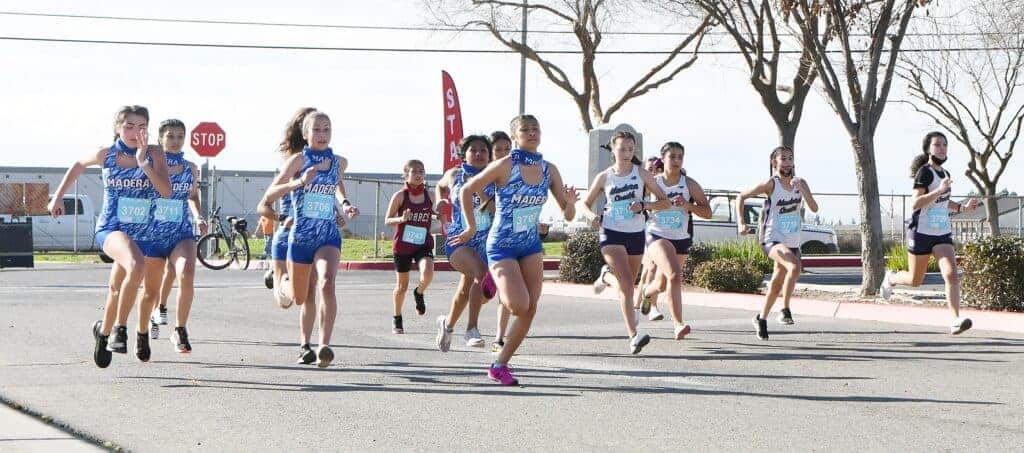 Photo - The Madera and Madera South girls cross country teams take off to begin the first athletic competition in 11 months. The teams ran in the Mad-Town Showdown on Friday at Madera South. Madera won the girls team race while Madera South won the boys team race.