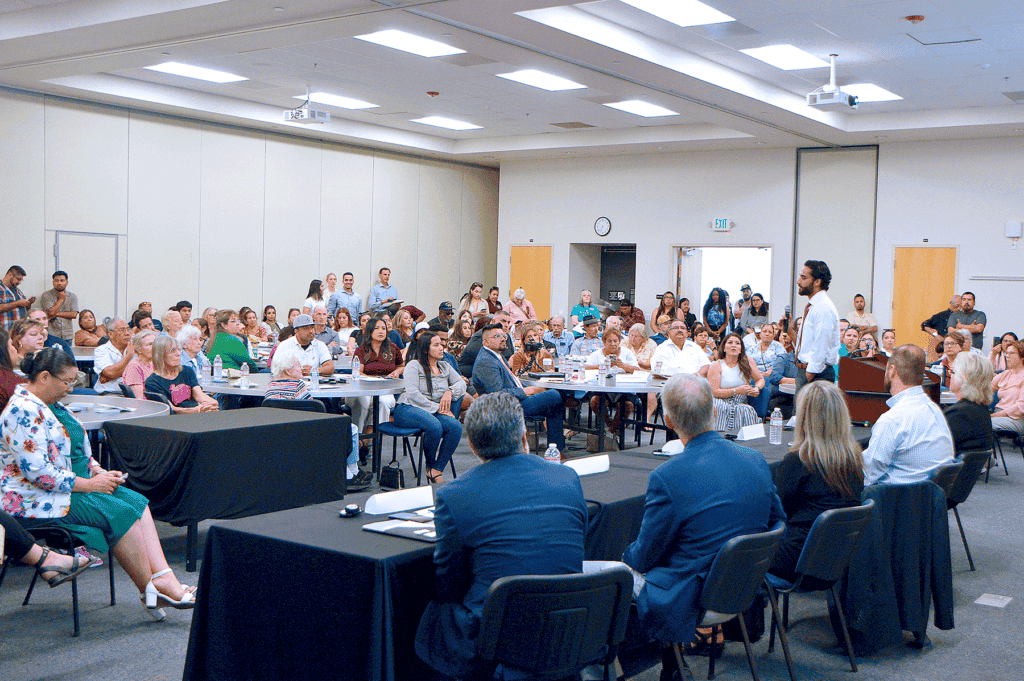 Photo - Manny Gahada, from American Advanced Management, describes to an audience of approximately 300 individuals the licensing and processes required in reopening Madera Community Hospital and shares images of the remodeling via a PowerPoint presentation Thursday evening.