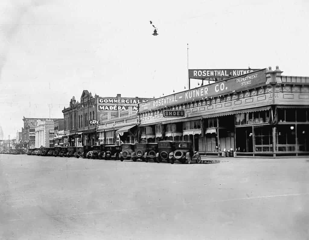 Photo - Looking east on Yosemite Avenue from E Street, this 1928 photograph shows the two-story building which housed the Masonic Lodge rooms, Athletic Hall, and the Opera House in its upper floor. It can be located in the middle of the block down from the Rosenthal-Kutner building.