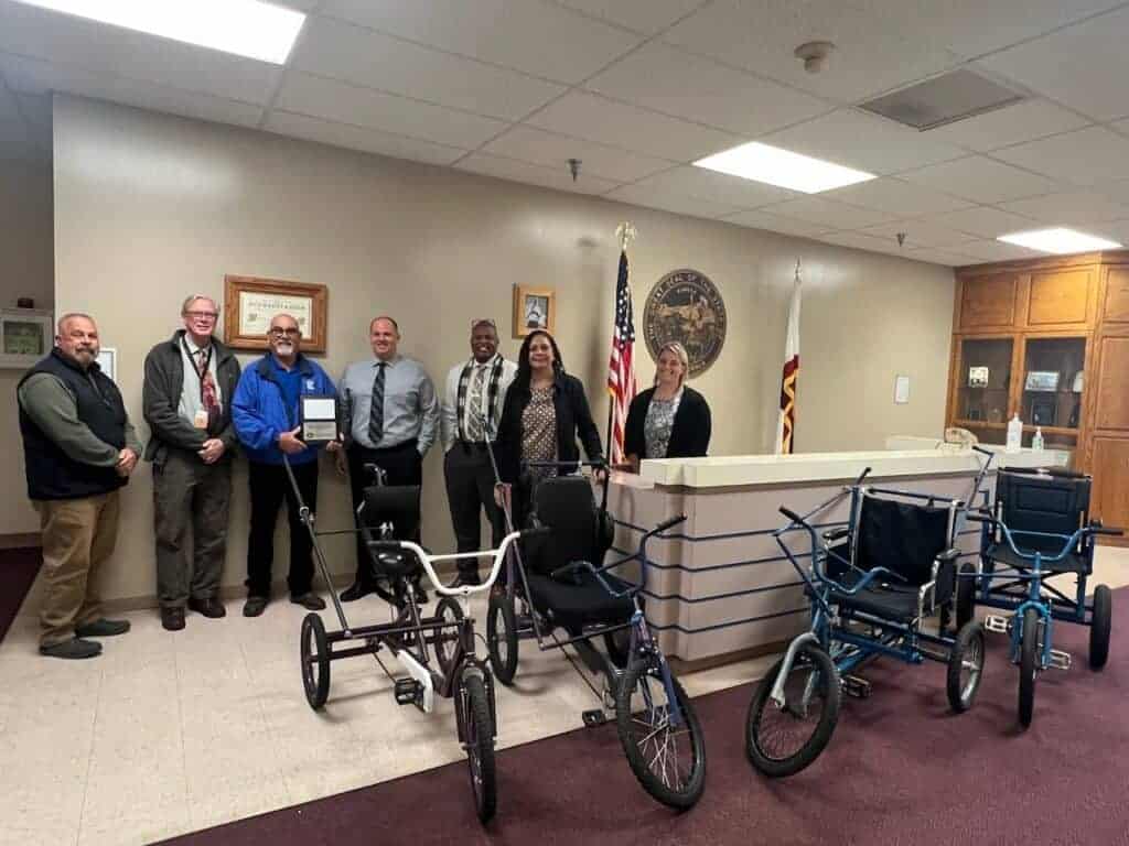 Photo - Valley State Prison workers pose with bicycles that were distributed to the Merced County Office of Education with the generosity of Madera GBS and Home Depot.