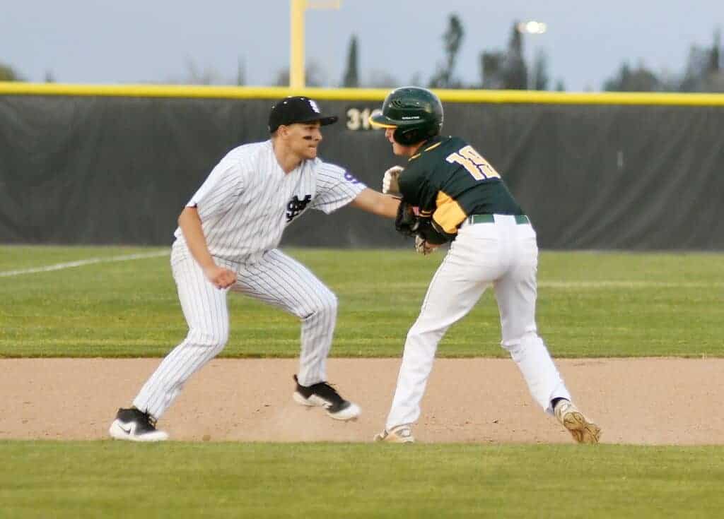 Photo - Madera South third baseman Caleb Bertoncini makes the tag to end a rundown during the Stallions’ 8-0 victory over Kingsburg on Thursday.