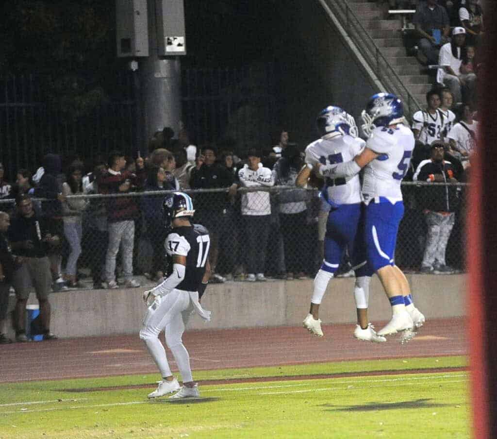 Photo - Madera’s Jacob Garcia (17) celebrates with Tommy Molina after a touchdown during Friday’s loss to Bullard.