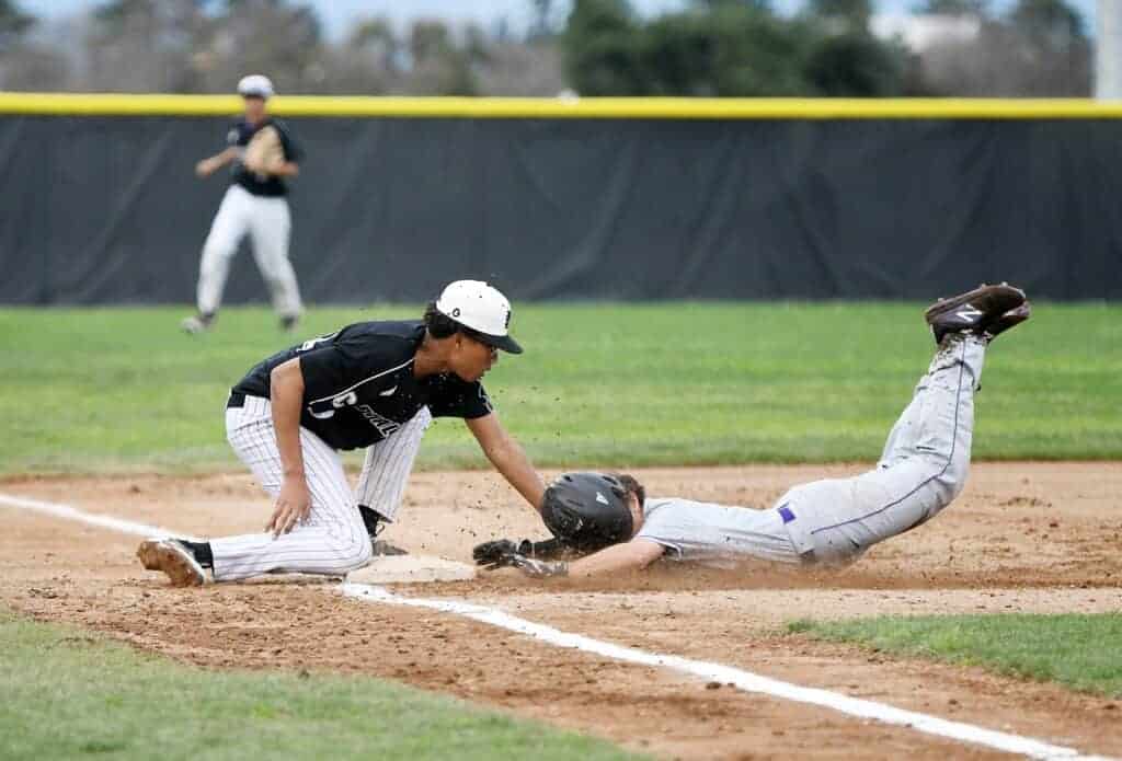 Photo - Madera South third baseman Jalen Gray makes the tag on Mission Oak’s Nate Watson, who tried to steal third in the second inning in Wednesday’s non-conference victory.