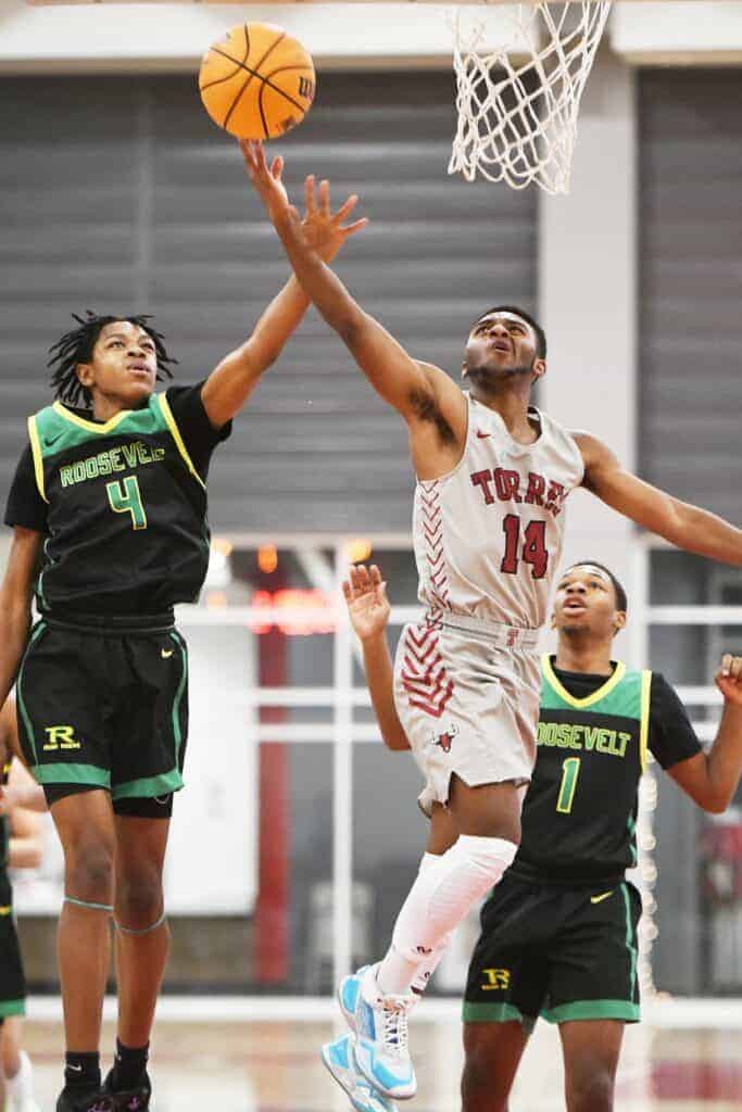 Photo - Matilda Torres’ Arturo Corona (14) drives to the bucket to score two of his team-high 24 points in Wednesday’s North Yosemite League loss to Roosevelt.