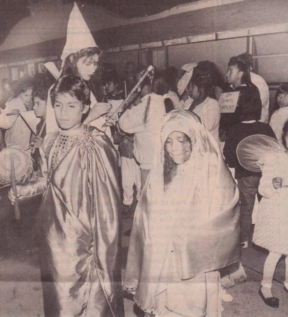 Photo - Jose Sanchez, left, and Maria Cardenas, right, played the role of Joseph and Mary 25 years ago in an updated version of the Posada to demonstrate the need for low income housing in Madera.