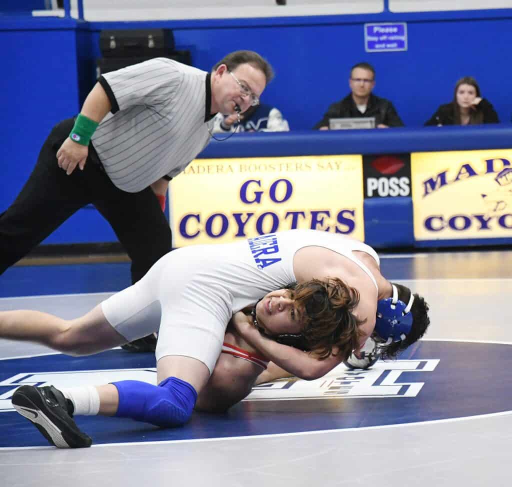 Photo - Madera 160-pounder Adan Madrigal gets his Sanger opponent into a pinning position during Wednesday’s dual meet victory.