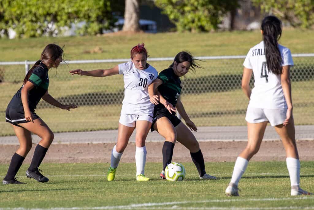 Photo - Madera South’s Noemi Alfaro (30) battles with Liberty’s Ashley Torres (12) for possession during Wednesday’s Div. II girls soccer first-round playoff game.