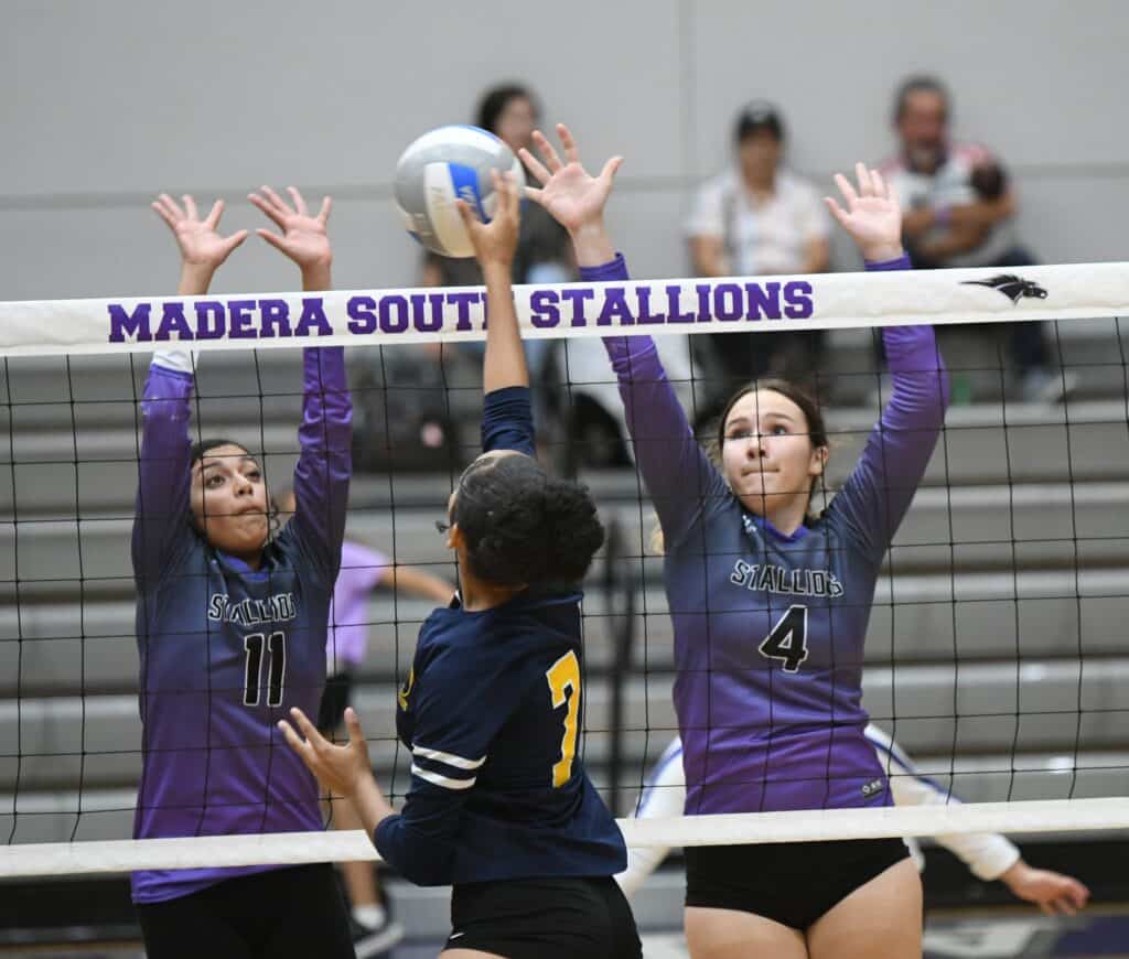 Photo - Madera South’s Erika Valdivia-Rodriguez (11) and Hannah Eades go up for a block attempt against Sunnyside. Eades put down 15 kills with five aces in Thursday’s five-set win.