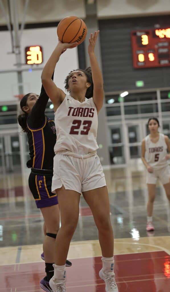 Photo - Matilda Torres’ J’Lynn Mitchell drives the lane to score two of her 13 points. She scored 10 points in a pivotal third quarter that gave the Toros a lead they wouldn’t relinquish.