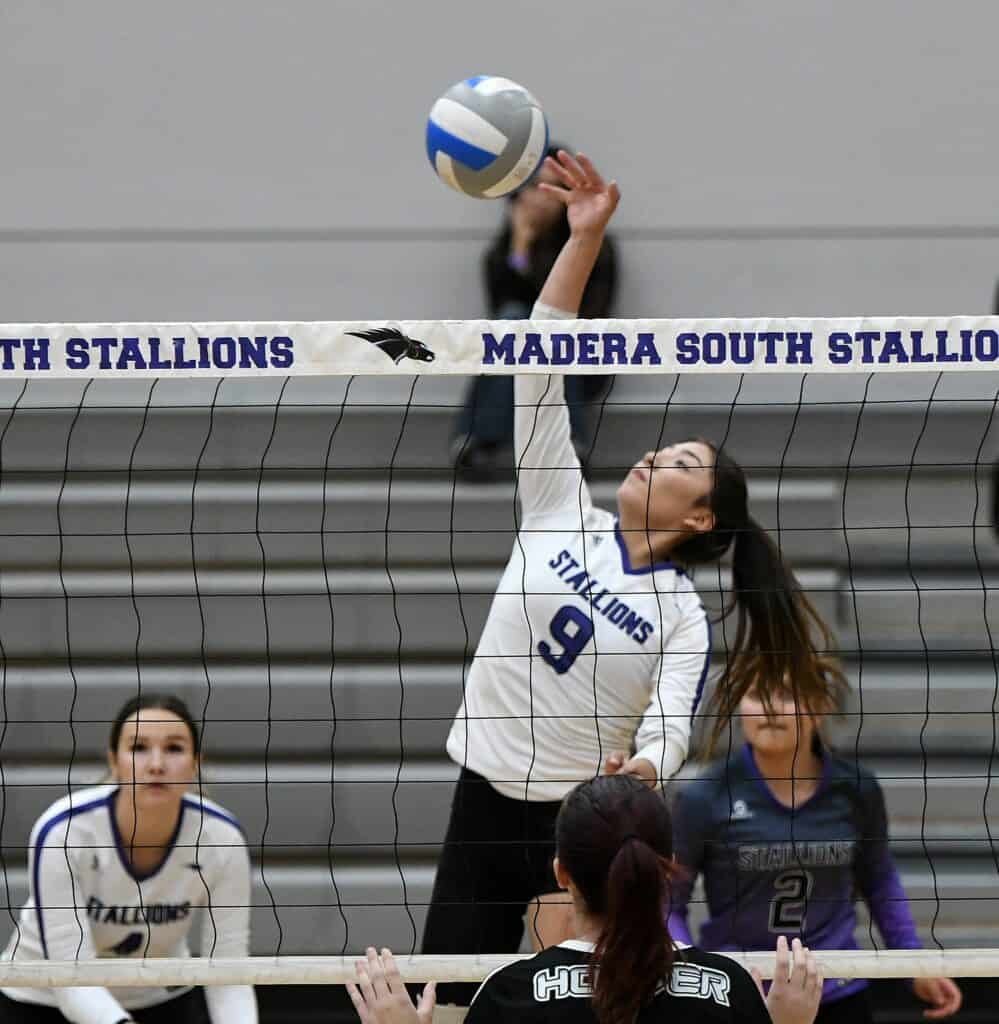 Photo - Madera South’s Danae Prudente rises up to put down one of her team-high 16 kills in Tuesday’s four-set loss to Hoover.