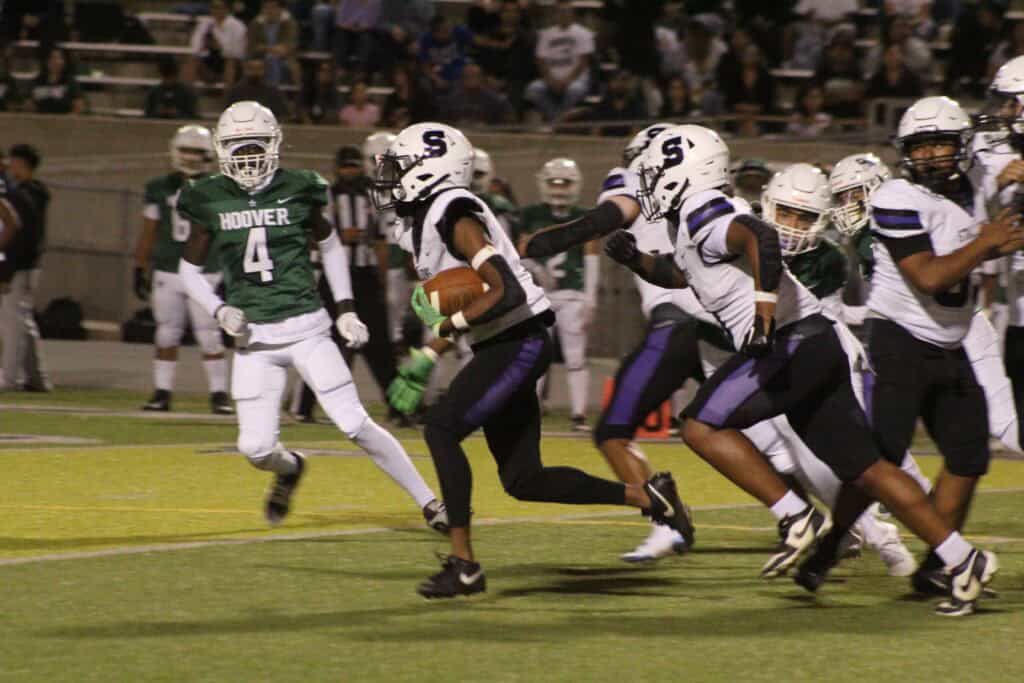 Photo - Madera South’s Corde McDonald speeds into the open field to score on a kick-off return to help Madera South to a first half lead Thursday against Hoover.