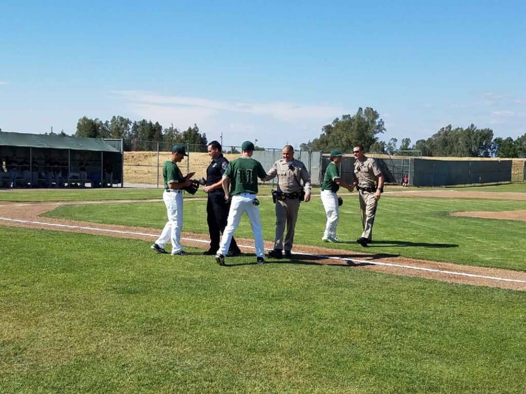 Photo - The Liberty Hawks baseball team honored first responders before Thursday’s playoff victory over Rosamond.