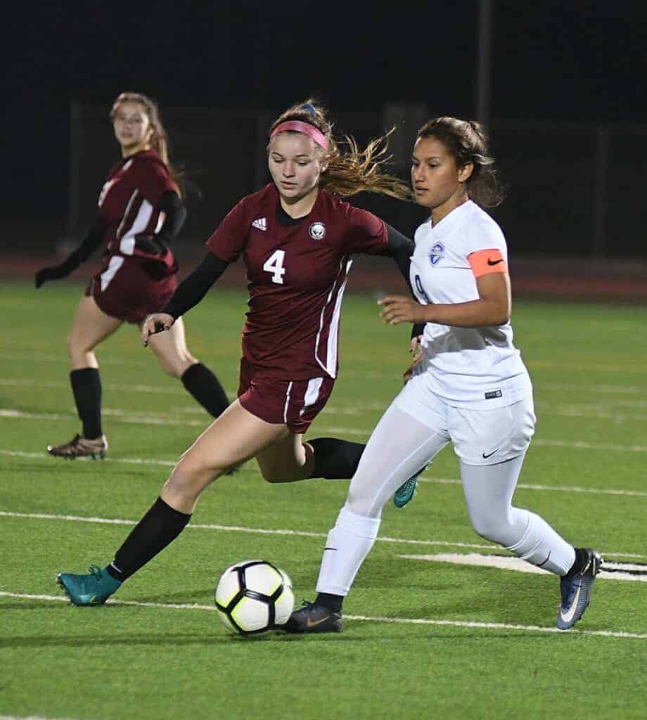 Photo - Madera midfielder Mia Alvarez (9) looks for an open teammate during Friday’s loss to Paso Robles during the first Madera Girls Soccer Showcase held in Memorial Stadium on Friday and Saturday.
