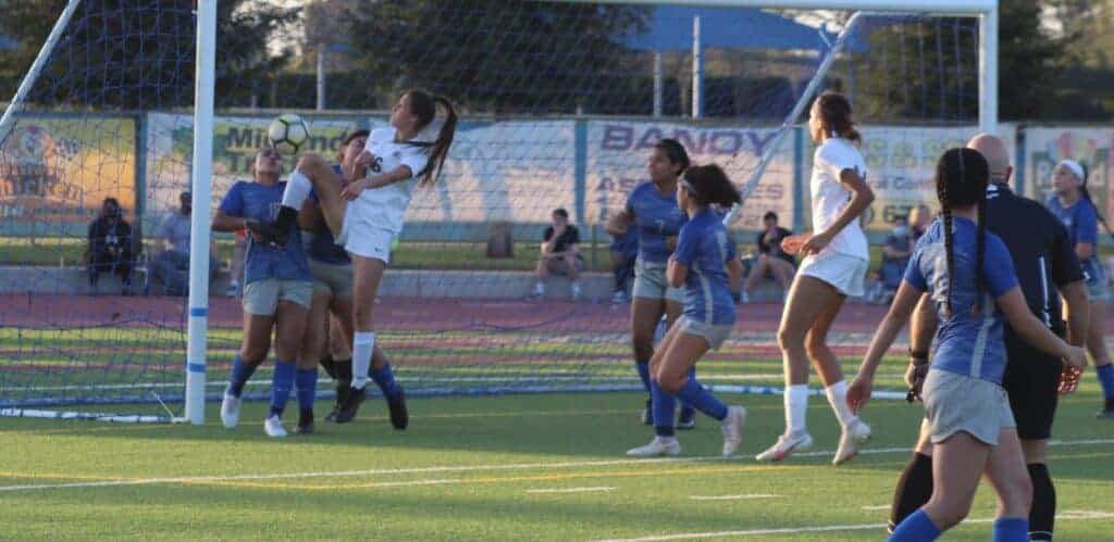 Photo - Madera defenders Madison Barba and Samantha Ruiz (18) battle against Central on a corner kick during Wednesday’s loss to the Grizzlies.