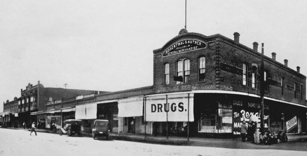 Photo - The first Rosenthal Kutner store, a two-story structure on the corner of D Street and Yosemite Avenue is shown here. It was a favorite spot for swapping local stories on Saturday nights.