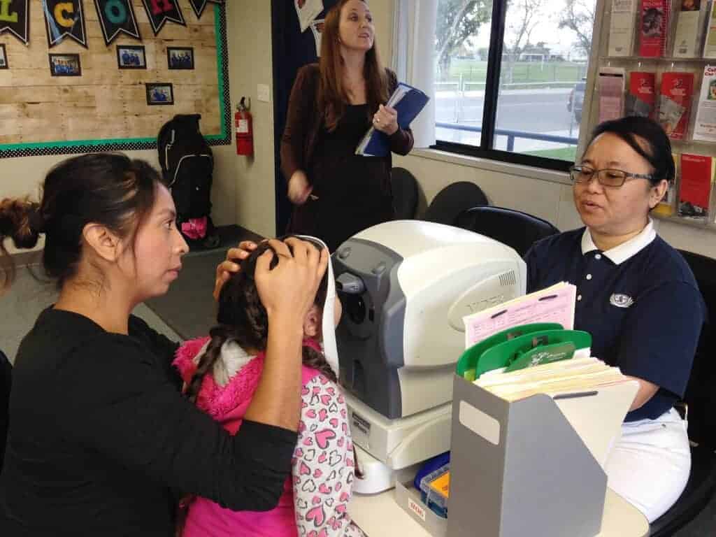 Photo - A preschooler gets her eyes checked on the Tzu Chi Vision Mobile Unit.