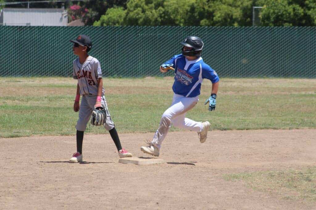 Photo - Madera National’s Kace Harris hits second base during his third inning triple during Saturday’s 11-2 victory over Selma in the District 10 9-11-year-old tournament. 