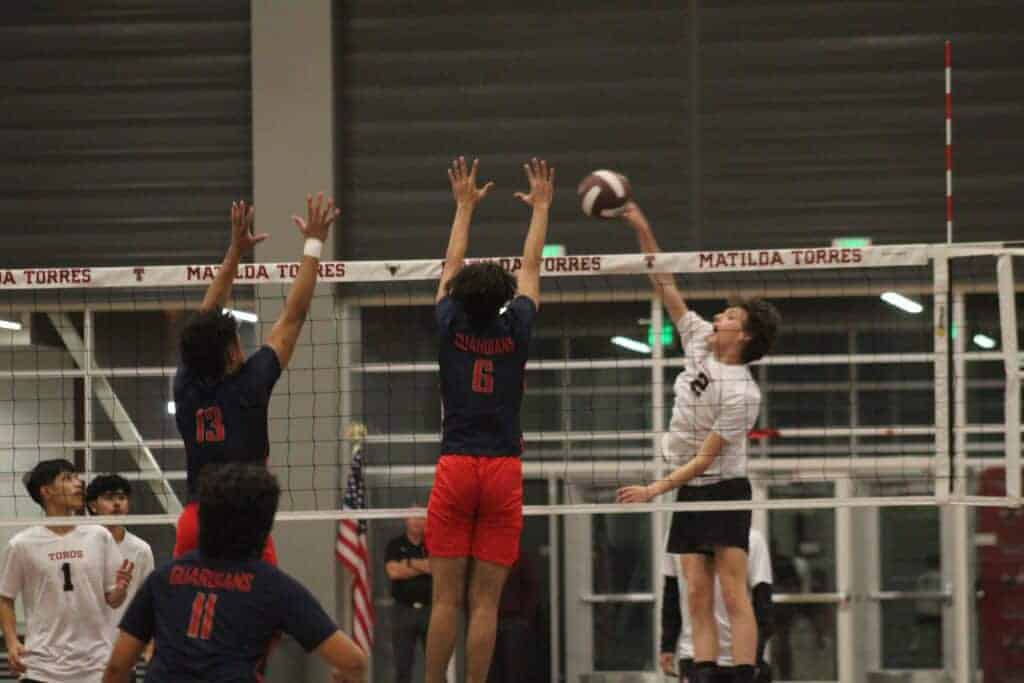 Photo - Matilda Torres’ Michael Lucero gets a kill past the Justin Garza block during Thursday’s five-set loss. Lucero led the Toros with 20 kills. 