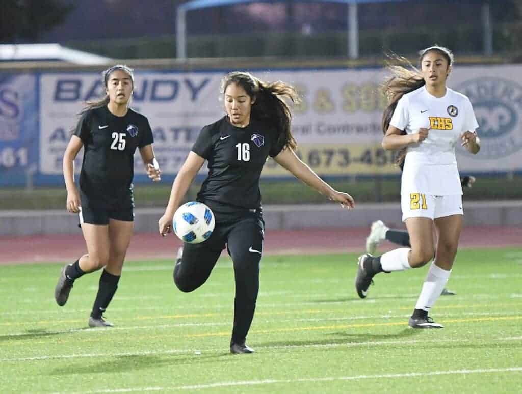 Photo - Madera South’s Jocelynn Rodriguez tries to clear the ball from the Stallions’ side of the field while Aaliyah Herrera (25) provides support.