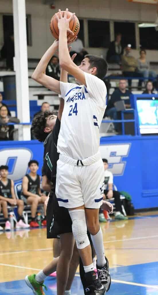 Photo - Madera’s Stevie Estrada gos up for a shot during Tuesday’s victory over the Reedley Pirates. He scored 16 points with 15 rebounds.