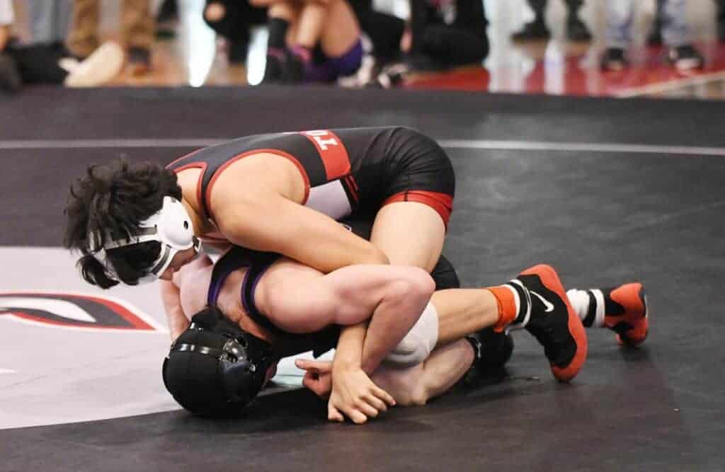 Photo - Matilda Torres’ Aiden Salas tries to earn near fall points on Madera South’s Nathan Leon during the 113-pound North Yosemite League championship match. Salas defeated Leal by a 7-1 decision. 
