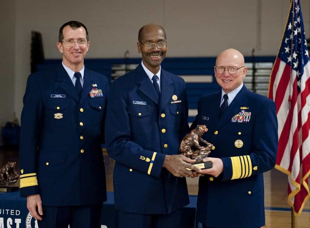 Photo - CWO Kirk Edwards receiving the “Spirit of the Bear Award” from the Commandant of the Coast Guard with the Superintendent of the Coast Guard Academy (Admiral Burhoe) pictured on the left.