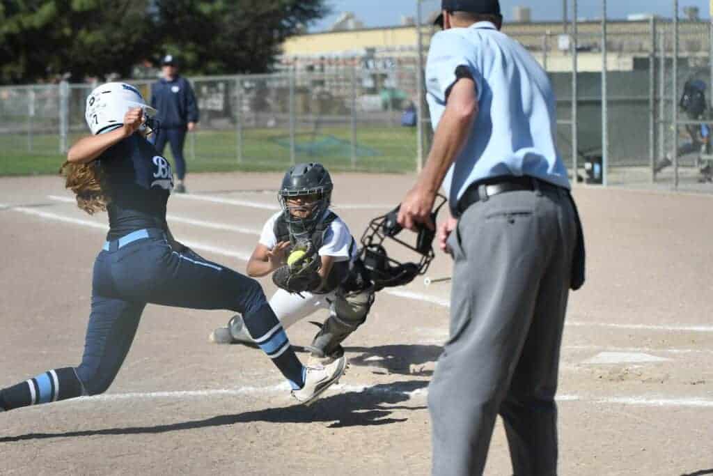 Photo - Madera South catcher Eliana Tovar reaches back to tag out Bullard’s Leilyn Alvarez trying to score during Tuesday’s 11-4 loss to the Knights.