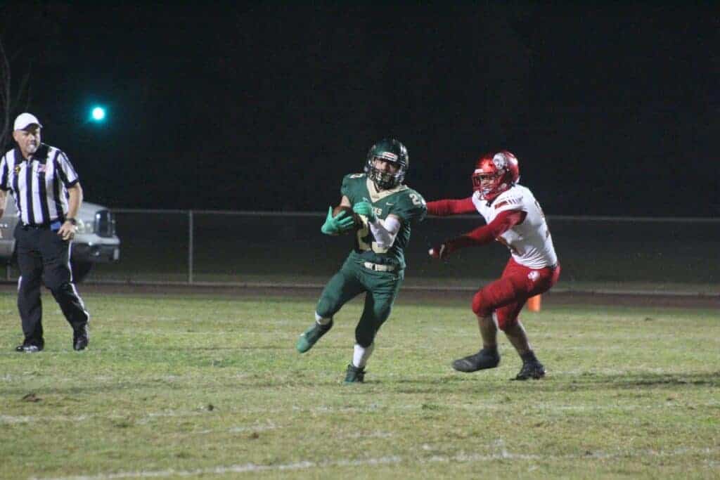 Photo - Liberty’s Dominic Castaneda escapes a tackler for a long gain Friday night. He had many of those in 238 yards rushing to go with five touchdowns.