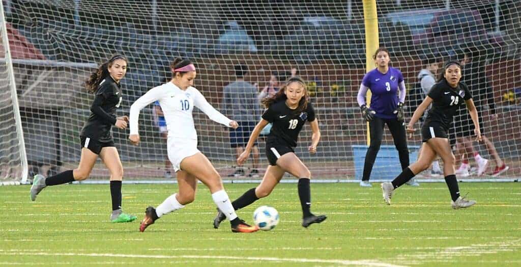 Photo - Madera’s Itzel Rodriguez (10) controls the ball in the midfield against Madera South’s Brianna Velasco. Rodriguez scored all four goals in a victory over the Stallions.
