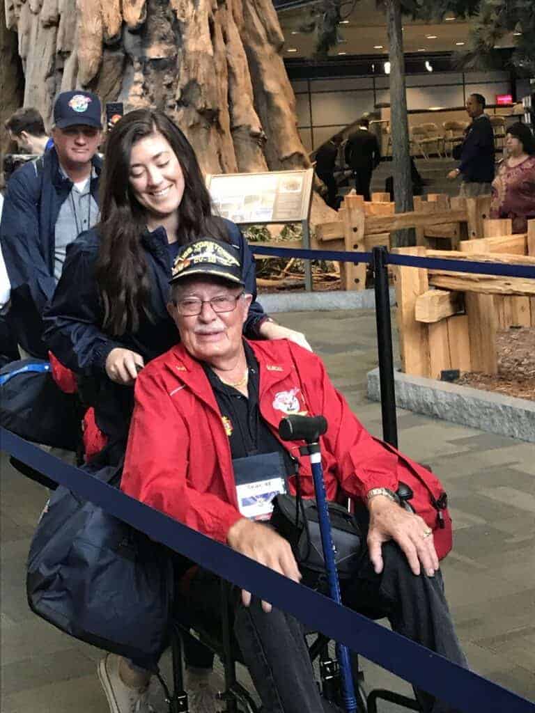 Photo - Charisa Kelly wheels her grandfather Bob McCracken through Fresno Yosemite International Airport upon his return from a three-day visit to Washington, D.C., as a member of the Honor Flight.