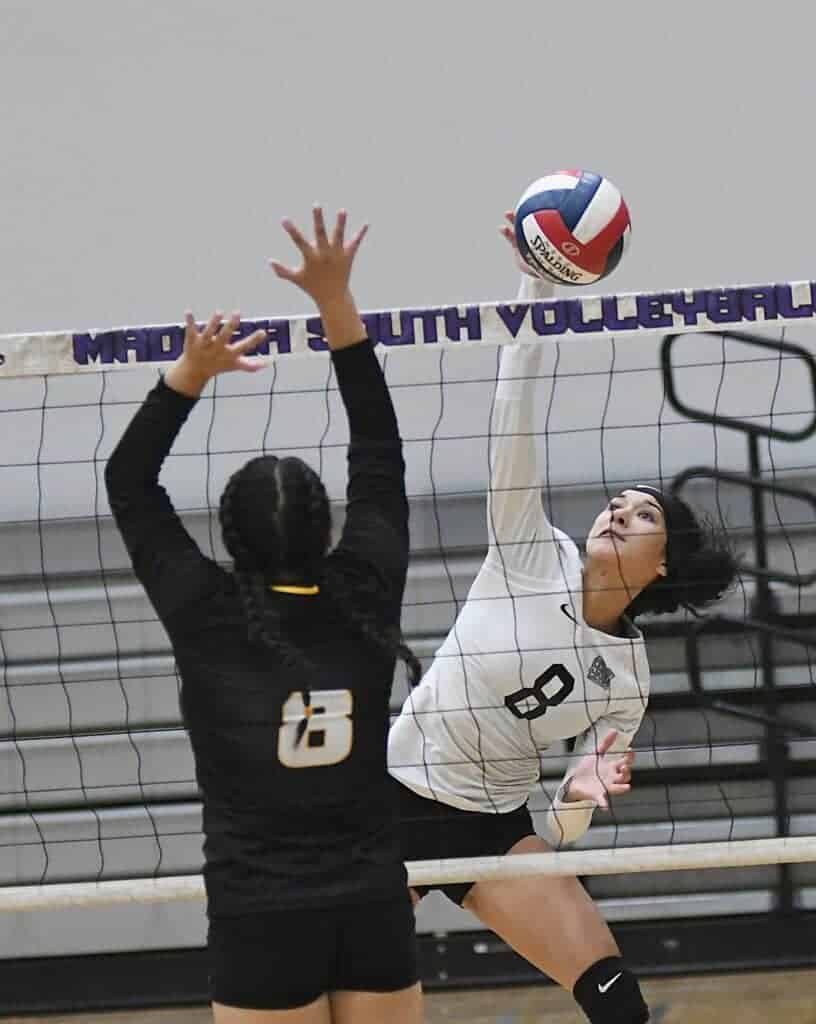 Photo - Madera South’s Aleecia Rosel sends a kill past the Edison blocker for one of her team high 11 kills.