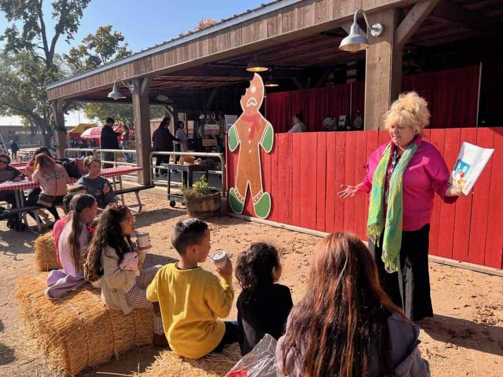 Photo - Children listen in during a storytime at the Madera Fair. Families are invited to bring their little ones for kid-friendly activities during the Hometown Holiday Market at the Madera Fair on Saturday.