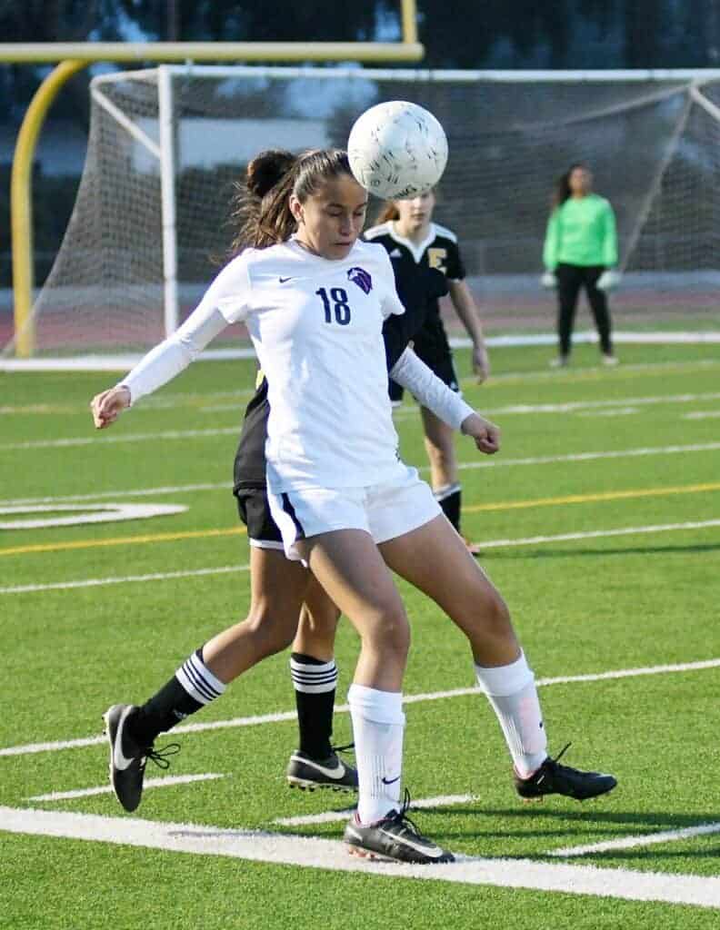 Photo - Madera South’s Jasmine Salazar heads the ball up the field to keep control for the Stallions. She scored Madera South’s only goal in a 6-1 loss to Edison on Wednesday.