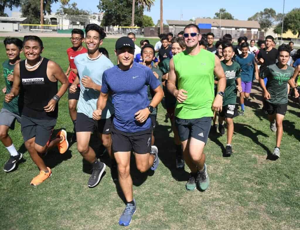 Photo - Madera South cross country coach and diabetes advocate Benny Madrigal takes a jog with his team. Madrigal says that exercise is one way to help control diabetes, a message he is sharing during Diabetes Awareness Month, which is November.