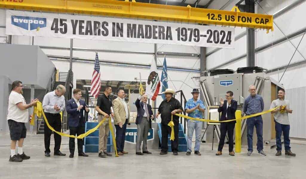Photo - Evapco cofounder Wilson Bradley, holds scissors up after cutting the ribbon in celebration of their new expansion and company’s 45th anniversary in Madera.
