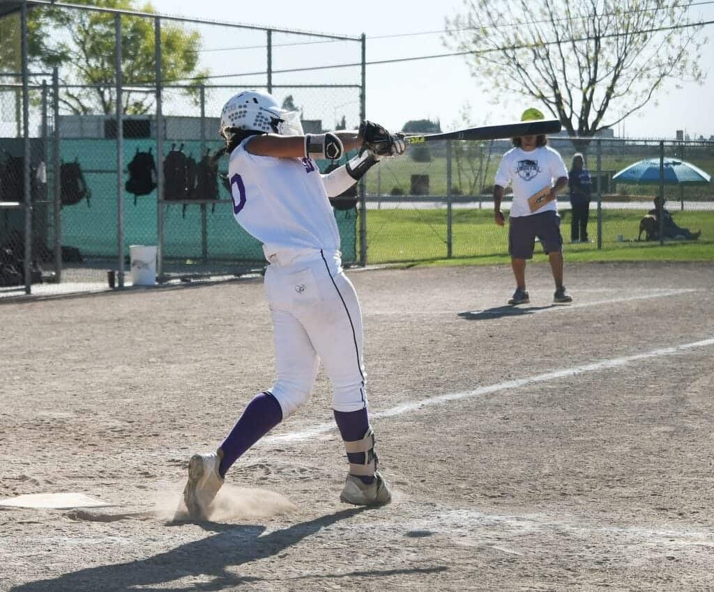 Photo - Madera South’s Savannah Garcia reaches up for one of her three hits to lead the Stallions to a 13-1 victory over San Joaquin Memorial on Friday.