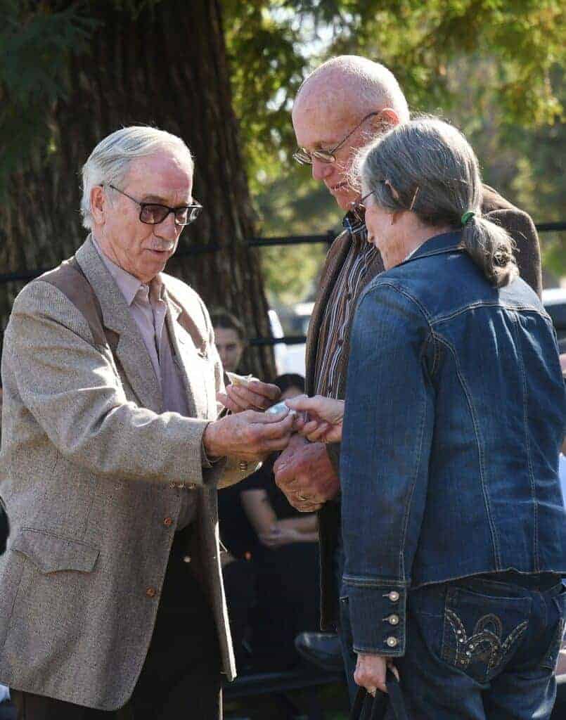 Photo - Madera County Supervisor chairman Tom Wheeler, left, presents Clay and Dusty Daulton with 125 year anniverary commemorative pins.