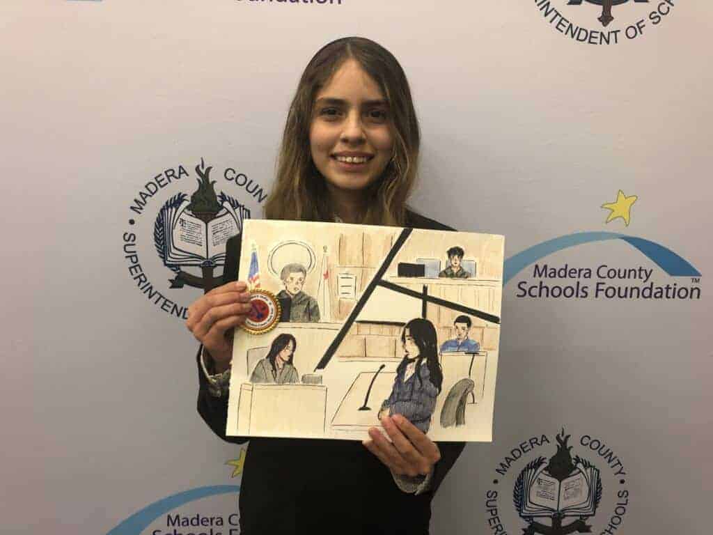 Photo - Beyonce Ramos from Madera South High School shows off her sketch of the proceedings to place first in the courtroom artist category. She will be one of two Madera County courtroom artists competing at the state level.