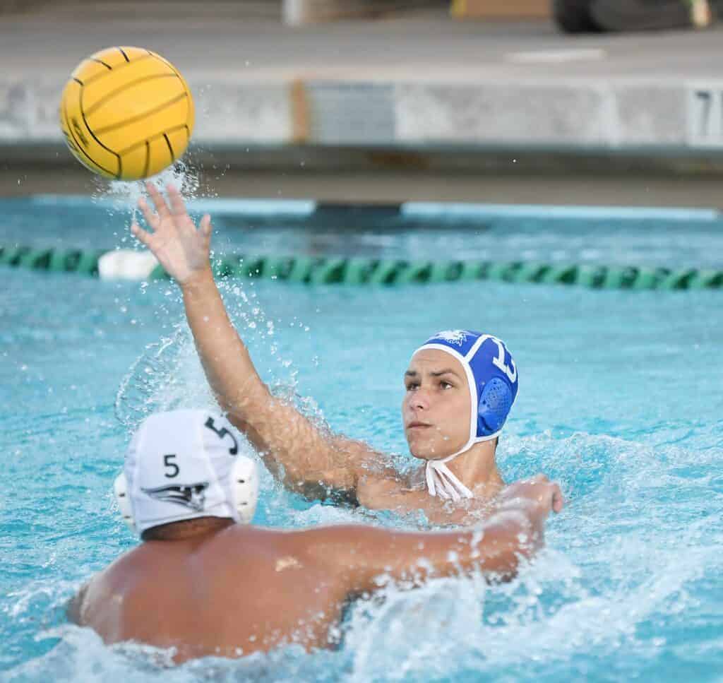 Photo - Madera’s Garrin Hatfield sends a pass away with a Hoover defender coming to him during Friday’s victory. Hatfield scored three times in the victory.