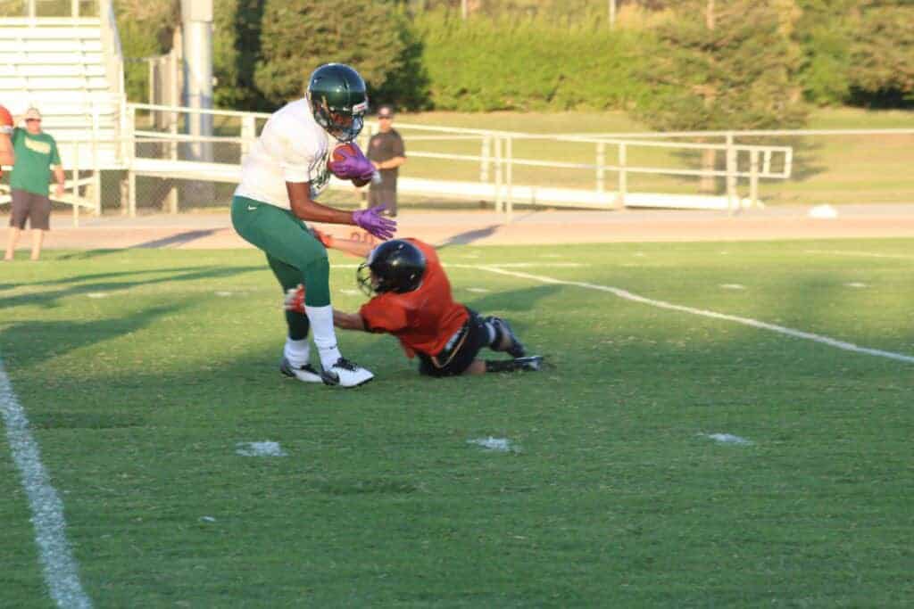 Photo - Liberty running back Quentin Stewart makes a move against a Coalinga defnder to score on a 35-yard touchdown run early in Friday’s scrimmage.