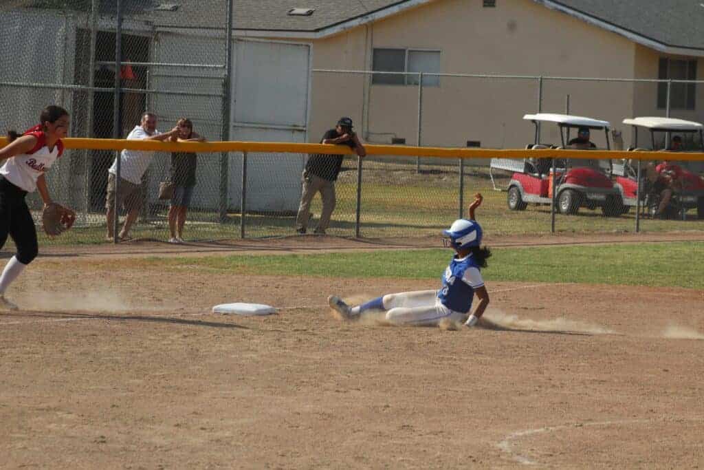 Photo - Madera’s Kailea Ricks slides in safely to third base after advancing on a fly ball. She led the Coyotes with three hits, but was left stranded during Wednesday’s 3-0 semifinal loss to top-seeded Hanford.
