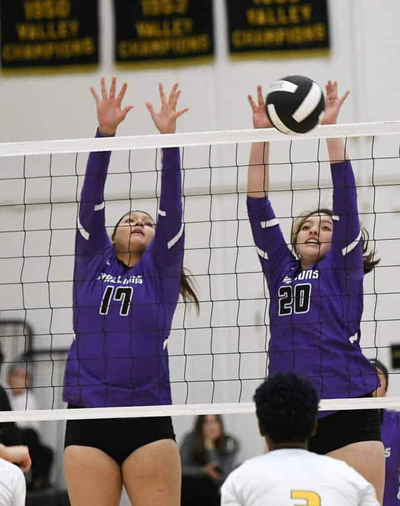 Photo - Madera South’s Arelis Chavez (17) and Destiny Perez (20) rise up for a block against an Edison attack during Tuesday’s victory.