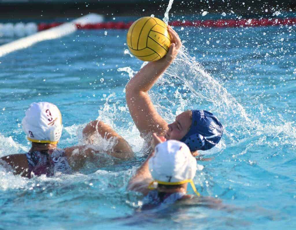 Photo - Madera’s Maddie McNeil fends off two defenders to try to score one of her five goals in Wednesday’s Div. II playoff victory over the Sierra Chieftains.