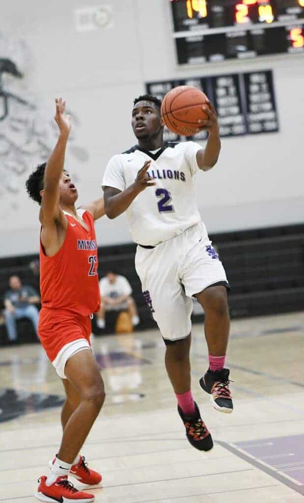 Photo - Madera South’s Jayshawn Thomas drives to the hoop to score two of his team-high 18 points Friday night.