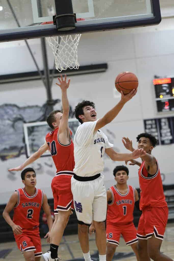 Photo - Madera South’s Julian Galvan goes up for a layup during Friday’s loss to the Sanger Apaches. He led the team with 17 points to go with 10 rebounds.