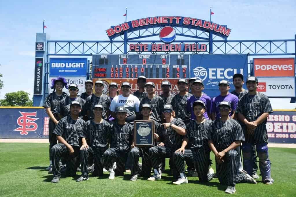 Photo - The Madera South Stallions baseball team celebrates with the Div. IV Championship plaque underneath the scoreboard at Pete Beiden Field at Bob Bennett Stadium at Fresno State on Saturday after a 5-3 victory over Lemoore.